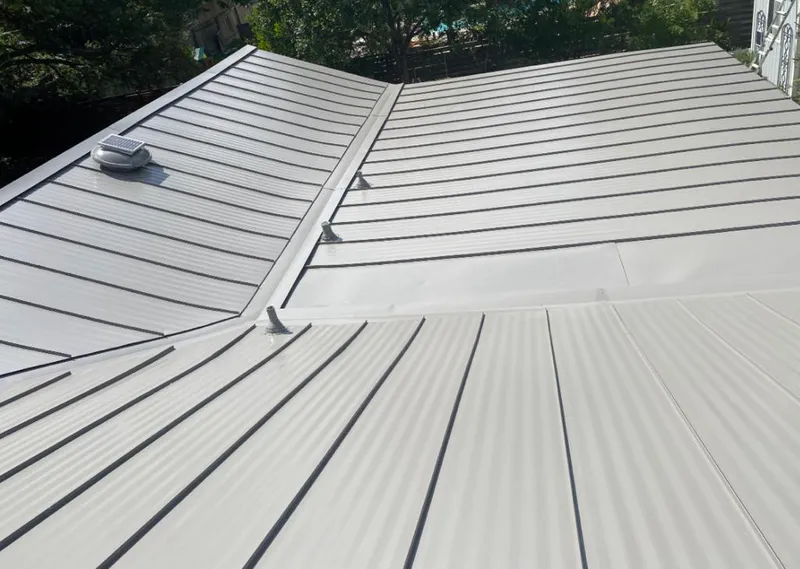 Solar attic fan installed on a metal roof for Roof Ventilation in Corinth